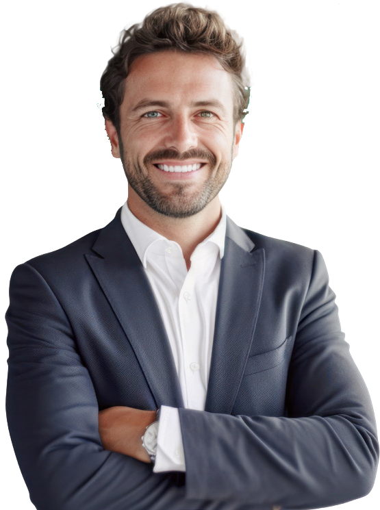 A smiling man with light brown hair and a beard, wearing a navy blue suit and white shirt, standing with arms crossed against a plain background.
